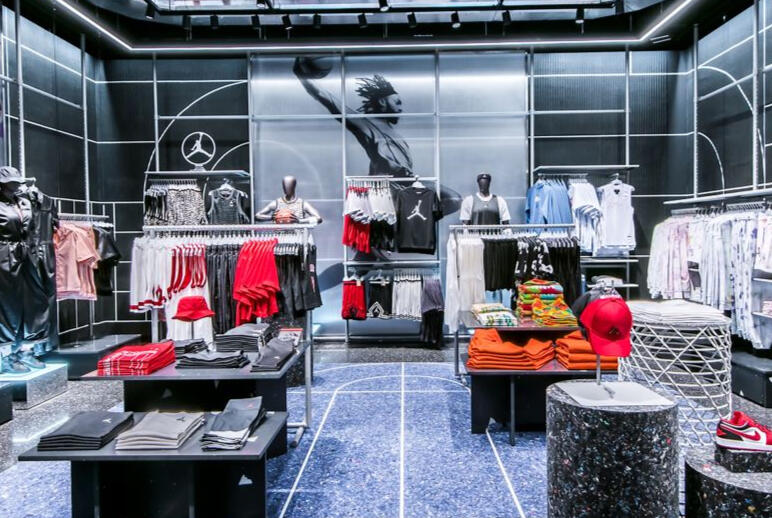 An interior view of a store featuring an array of clothing and shoes arranged for display